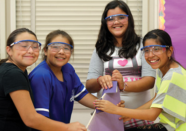 oung women from the group DIY Girls sand a piece a wood they will use in an interactive game they designed. DIY Girls runs programs for Latina girls at L.A.’s Telfair Elementary School, pictured, and Vaughn Next Century Learning Center. Photo by Youth Speak Media Solutions (courtesy of DIY Girls)